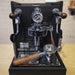 Espresso machine with wooden handles on a wooden surface.
