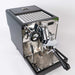 Espresso machine with metallic finish on a white background