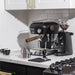 Black espresso machine with a grinder on a kitchen counter.