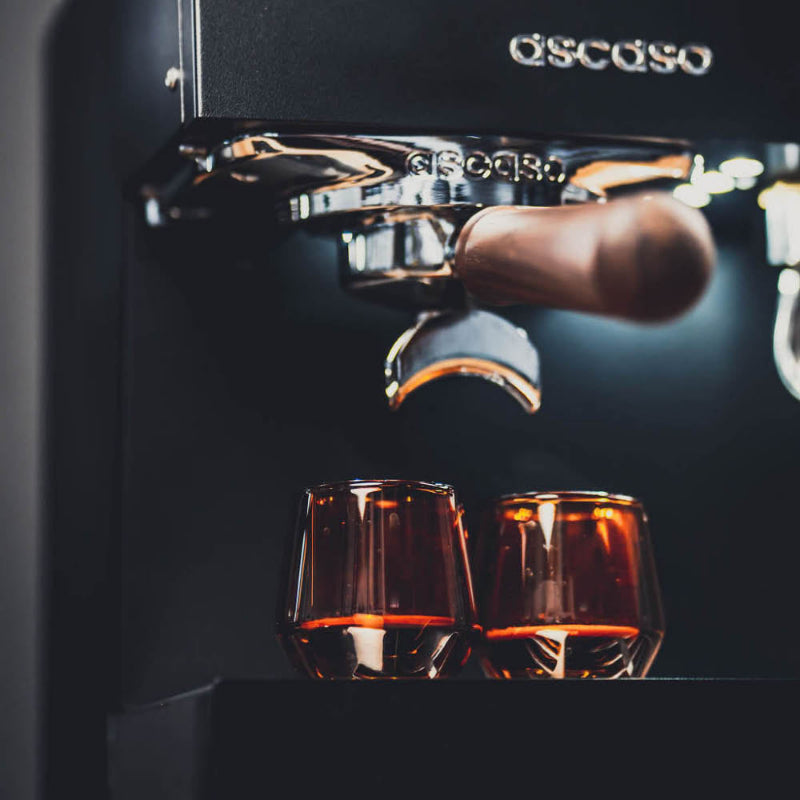 Espresso machine with two glasses of coffee below, featuring the Gaggia brand.